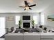 Inviting living room with a ceiling fan, fireplace, and comfortable seating at 58 Butterbean Ct, Zebulon, NC 27597