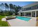 A pristine backyard featuring a pool and a stone spa with mature trees at 6 Castlewood Dr, Durham, NC 27713