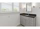 Bathroom vanity featuring gray cabinets and modern lighting at 6 Castlewood Dr, Durham, NC 27713