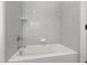 Bright white bathroom with subway tiled walls and a bathtub at 6 Castlewood Dr, Durham, NC 27713
