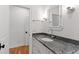 Bathroom vanity featuring granite counters, chrome fixtures, and white cabinets at 6 Castlewood Dr, Durham, NC 27713