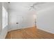 Bright bedroom features wood floors, a ceiling fan, and large closet doors at 6 Castlewood Dr, Durham, NC 27713