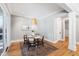 Cozy dining area with a round table, four chairs, decorative rug, and natural lighting at 6 Castlewood Dr, Durham, NC 27713