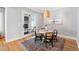 Charming dining area features a round table, four chairs, a wicker light fixture, and neutral paint at 6 Castlewood Dr, Durham, NC 27713