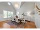 Bright dining room features large windows, hardwood floors, and a modern chandelier at 6 Castlewood Dr, Durham, NC 27713