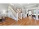 Open-concept entryway boasts hardwood floors, elegant staircase, and seamless transition to the living area at 6 Castlewood Dr, Durham, NC 27713