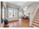 Grand foyer with hardwood floors, staircase, and elegant lighting fixture at 6 Castlewood Dr, Durham, NC 27713