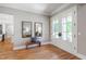 Inviting foyer with hardwood floors, bench seat, and double doors leading to the outside at 6 Castlewood Dr, Durham, NC 27713