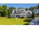 Stunning gray house boasts a manicured lawn and mature trees at 6 Castlewood Dr, Durham, NC 27713