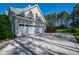 Spacious three-car garage with white doors and ample driveway space for convenient parking and storage at 6 Castlewood Dr, Durham, NC 27713