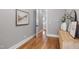 Inviting hallway features hardwood floors, neutral paint, and leads to a staircase at 6 Castlewood Dr, Durham, NC 27713