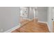 Hallway features hardwood floors, neutral paint, and leads to other rooms at 6 Castlewood Dr, Durham, NC 27713