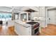 Bright kitchen featuring a large island, Wolf range, and white cabinets with marble countertops at 6 Castlewood Dr, Durham, NC 27713