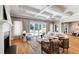 Elegant living room featuring a fireplace, coffered ceiling, and access to a patio and pool area at 6 Castlewood Dr, Durham, NC 27713