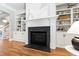 Living room features a cozy fireplace with detailed mantle and built-in bookcases on each side at 6 Castlewood Dr, Durham, NC 27713
