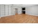 Open living room with a wet bar, custom built-ins and hardwood floors at 6 Castlewood Dr, Durham, NC 27713