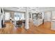 Bright living room featuring hardwood floors, fireplace, and seamless open flow to kitchen and outdoor views at 6 Castlewood Dr, Durham, NC 27713
