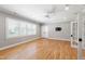 Spacious room featuring hardwood floors, a ceiling fan, natural light, and French doors at 6 Castlewood Dr, Durham, NC 27713