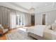 Bright main bedroom with hardwood floors, a crystal chandelier, and sliding glass doors at 6 Castlewood Dr, Durham, NC 27713