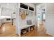 Mud room with storage hooks, a bench, custom shelves, and easy access to the kitchen at 6 Castlewood Dr, Durham, NC 27713