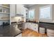 Well-lit office space featuring a built-in desk, custom cabinets, and bright windows at 6 Castlewood Dr, Durham, NC 27713