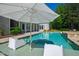 Pool with lounge chairs and umbrella provides a serene backyard oasis at 6 Castlewood Dr, Durham, NC 27713