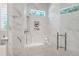 Luxurious shower with marble tile, a built-in bench, and sleek shower hardware at 6 Castlewood Dr, Durham, NC 27713