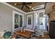 Covered outdoor living area with a brick fireplace and a view of the pool at 6 Castlewood Dr, Durham, NC 27713