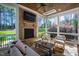 The sunroom features a brick fireplace, stone flooring, and outdoor views at 6 Castlewood Dr, Durham, NC 27713