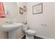 Cozy half bath with pedestal sink and framed decorative wall art at 608 Grand Central Sta, Apex, NC 27502