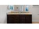 Bathroom featuring a dual sink vanity with granite countertop and dark wood cabinetry at 608 Grand Central Sta, Apex, NC 27502