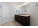 Bathroom features a double vanity with granite countertops, a large mirror, and modern lighting at 608 Grand Central Sta, Apex, NC 27502
