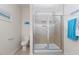 Bright bathroom showcasing a tiled walk-in shower with glass doors and white trim at 608 Grand Central Sta, Apex, NC 27502