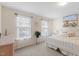 Bright bedroom with large windows, light-colored walls, and a cozy bed adorned with decorative pillows at 608 Grand Central Sta, Apex, NC 27502