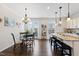 Charming dining area with modern chandelier and granite kitchen island at 608 Grand Central Sta, Apex, NC 27502