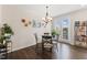 Bright dining area featuring a glass-top table, designer chandelier, and natural light at 608 Grand Central Sta, Apex, NC 27502