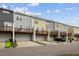 Stylish townhome exteriors with decks offer modern living and convenient parking at 608 Grand Central Sta, Apex, NC 27502