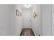 Bright hallway featuring neutral walls, decorative wall art, and a patterned rug leading to the front door at 608 Grand Central Sta, Apex, NC 27502
