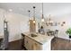 Open-concept kitchen featuring a granite island, stainless appliances, and adjacent dining area at 608 Grand Central Sta, Apex, NC 27502