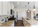 Well-equipped kitchen with white cabinetry, granite countertops, and stainless steel appliances at 608 Grand Central Sta, Apex, NC 27502