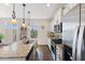 Well-lit kitchen featuring stainless steel appliances, granite counters, and a center island at 608 Grand Central Sta, Apex, NC 27502