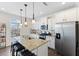 Bright kitchen featuring white cabinets, stainless steel appliances, and island with seating at 608 Grand Central Sta, Apex, NC 27502