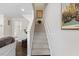 Bright staircase leading to the upper level, with neutral carpet and white walls at 608 Grand Central Sta, Apex, NC 27502