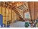 Unfinished attic with wooden beams and exposed insulation, offering potential for customization at 625 Canvas Dr, Wake Forest, NC 27587