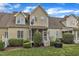 View of the home’s back exterior showing patio and lush greenery at 625 Canvas Dr, Wake Forest, NC 27587