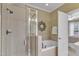 Elegant bathroom features a glass shower, soaking tub, and neutral tile throughout for a spa-like experience at 625 Canvas Dr, Wake Forest, NC 27587
