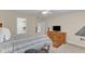 Cozy bedroom featuring neutral walls, ceiling fan, walk in closet and wooden furnishings at 625 Canvas Dr, Wake Forest, NC 27587