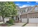 Charming brick townhome featuring attached garage, landscaped front yard, and welcoming entryway at 625 Canvas Dr, Wake Forest, NC 27587