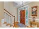 Welcoming foyer with hardwood floors, staircase, and charming decor at 625 Canvas Dr, Wake Forest, NC 27587