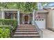 Inviting brick staircase leading to a covered front porch with columns and decorative plants at 625 Canvas Dr, Wake Forest, NC 27587
